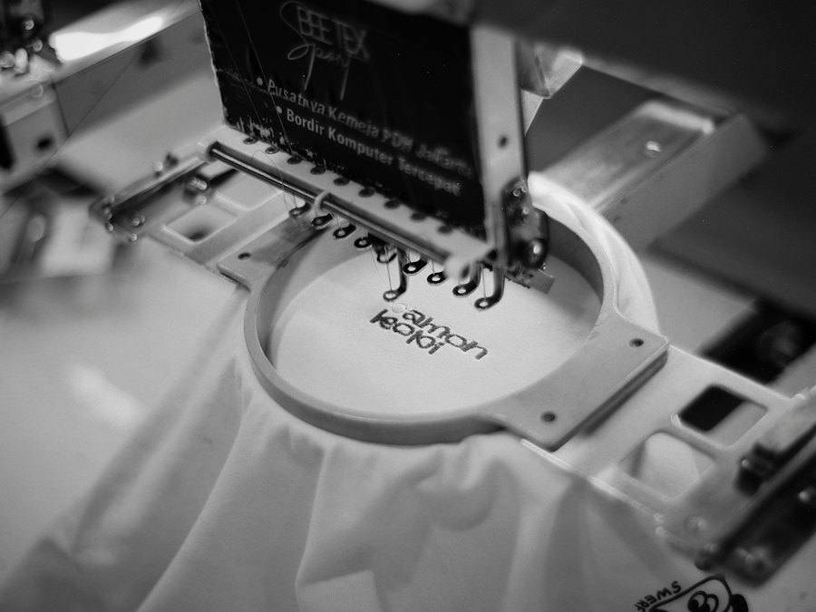 Embroidery machine stitching a logo